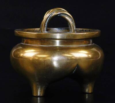 A Chinese bronze tripod censer, with bulbous body and twisted loop handles, six character Xuande seal mark to the base, probably 18thC, 9cm high, 10cm diameter. - 2