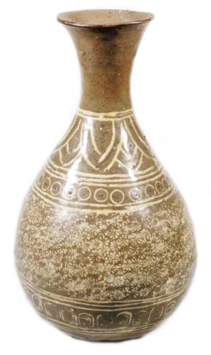 A Korean type pottery Buncheong design vase, stamped with a repeat floral pattern with an upper flower and orb decoration, on circular foot, glazed in cream and brown, 23cm high.