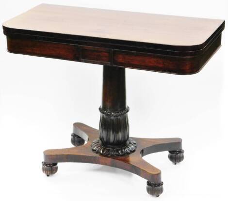 An early 19thC rosewood card table, the rounded top raised on a heavy gun barrel and floral column, terminating in an inverted H shaped platform base, with shaped feet, when closed 72cm high, 91cm wide, 45cm deep.