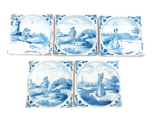 Five 18thC Dutch delftware tiles, decorated with men and women in rural settings, within circular reserves, 12.5cm.