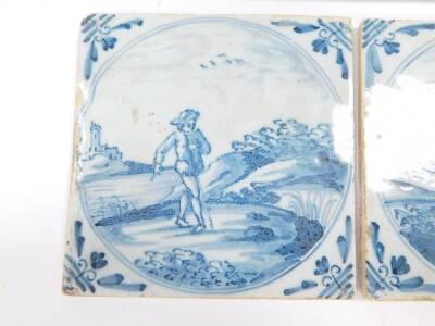 Five 18thC Dutch delftware tiles, decorated with men and women in rural settings, within circular reserves, 12.5cm. - 2