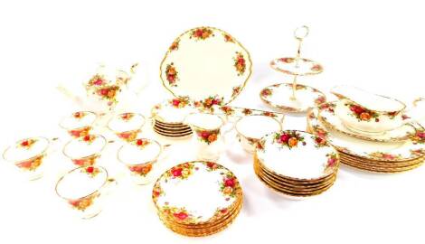 A Royal Albert porcelain part dinner and tea service, decorated in the Old Country Roses pattern, comprising sauce boat on stand, six dinner plates and fruit bowls, teapot, two tier cake stand, bread plate, cream jug, sugar bowl, six cups, saucers and tea