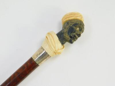 A snake wood walking stick, with an ebony and ivory carved figural handle of a Moor, white metal ferrule and ivory tip, 97.5cm high. - 2