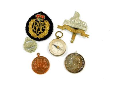 A Great War medal named to Pte A Winning ASC, M2-103766, Royal Tank Regiment badge, Lincolnshire Regiment cap badge, German pocket compass, RAF badge, and a Johannesburg medal Peace With Honour 1914-1919.