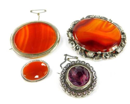 Three Victorian silver and agate brooches, together with a silver and amethyst brooch.