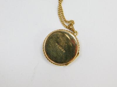 A 9ct gold circular double photo locket, foliate engraved, on a curb link neck chain, 8.8g all in. - 3