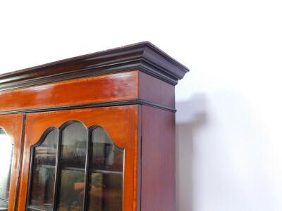 An Edwardian mahogany and satinwood cross banded bureau bookcase, the outswept pediment over base doors, opening to reveal three shelves, above a fall flap, opening to reveal drawers and recesses, above four long graduated drawers, raised on bracket feet, - 3