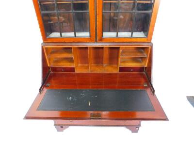 An Edwardian mahogany and satinwood cross banded bureau bookcase, the outswept pediment over base doors, opening to reveal three shelves, above a fall flap, opening to reveal drawers and recesses, above four long graduated drawers, raised on bracket feet, - 4