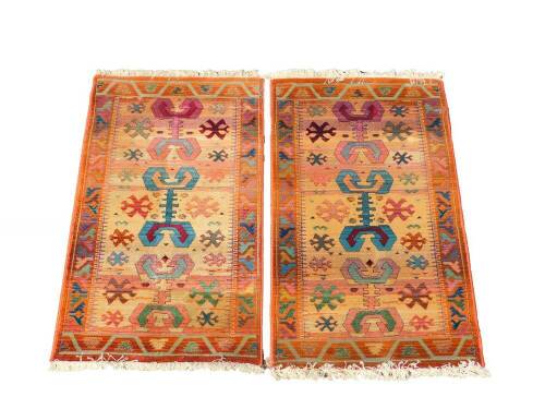 A pair of Egyptian Gabbeh Rug Collection rugs, decorated with nomadic tarantula type motifs and flowers, against a fair coloured ground, in a varied coloured border, 140cm x 80cm. (2)