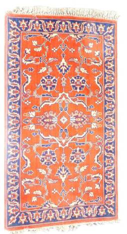 A Caucasian red ground rug, decorated with floral and foliate motifs, 170cm x 88cm.