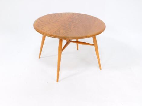 An Ercol 1960's elm drop leaf occasional table, raised on turned ash tripod legs, untied by stretchers, 60.5cm wide, 36.5cm deep, 61cm extended.