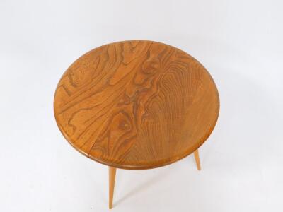 An Ercol 1960's elm drop leaf occasional table, raised on turned ash tripod legs, untied by stretchers, 60.5cm wide, 36.5cm deep, 61cm extended. - 2