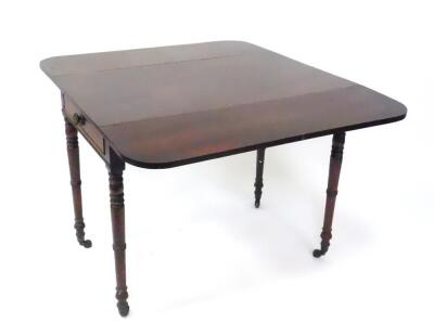 A George IV mahogany Pembroke table, with single frieze drawer raised on turned legs, brass capped on castors, 58cm wide, 111cm extended, 96.5cm deep, 73cm high. - 2