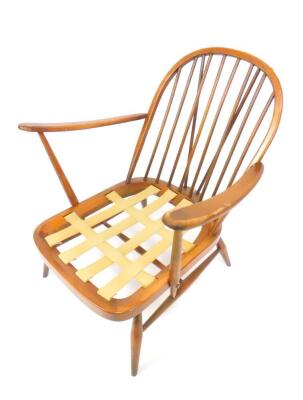 An Ercol model 203 oak armchair, Windsor style with loose cushion seat and back, raised on turned legs. - 2