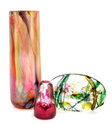 An Isle of Wight glass cylindrical vase, decorated with streaks of red purple and yellow, 27.5cm high, paperweight sculpture moulded with flowers, 16.5cm wide, and a Caithness paperweight decorated in the Nova pattern. (3)