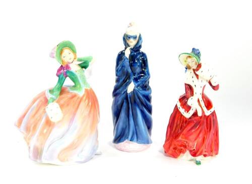 Three Royal Doulton figures, modelled as Christmas Morn HN1992, Masque HN2554, and Autumn Breezes HN1911.