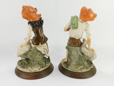 A pair of Capodimonte porcelain figures of a shepherd and shepherdess, monogrammed, raised on a circular wooden socle base, 30.5cm high. - 2