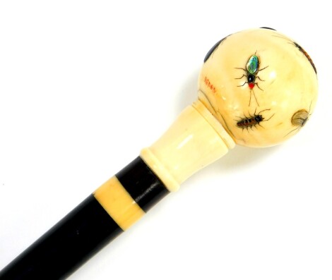 An ebony walking stick, with ivory collar and ball knop, Shibayama decorated with insects, ivory capped, 91.5cm high..