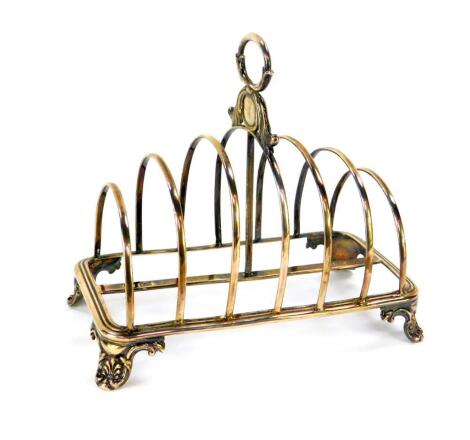 A William IV silver six division toast rack, raised on acanthus leaf scroll feet, Henry Wilkinson & Company, Sheffield 1837, 7.01oz.