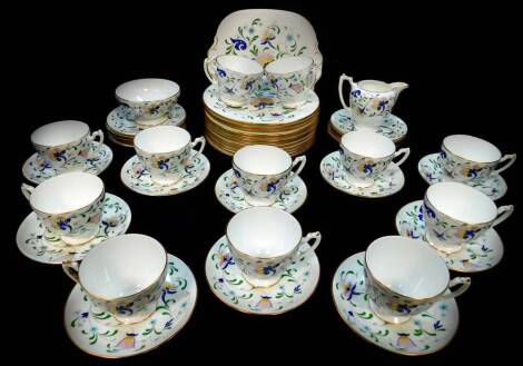 A Coalport porcelain tea service decorated in the Pageant pattern, comprising cream jug and sugar bowl, bread plate, twelve tea cups, ten saucers and twelve tea plates, together with twelve salad plates.