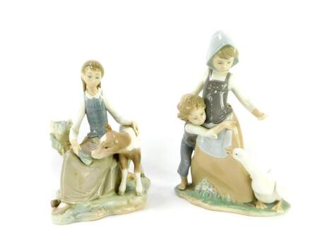 A Lladro porcelain figure group, modelled as a girl and younger boy with goose, 25.5cm high, and a further figure group modelled as a seated girl with calf, 19cm wide. (2)