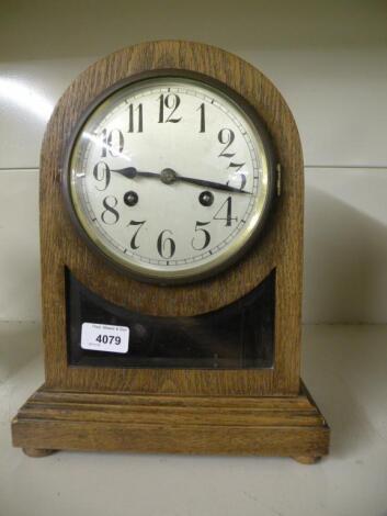 An Edwardian oak mantel clock