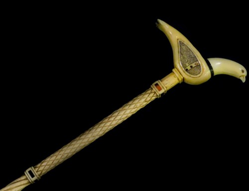 A 19thC whale bone walking cane, with a spiral twist and cross hatched shaft, tortoiseshell inlaid collars, and sperm whale tooth handle, carved as a dove, 82cm high.