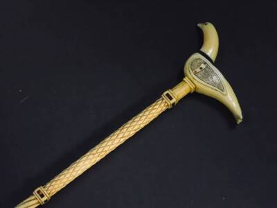 A 19thC whale bone walking cane, with a spiral twist and cross hatched shaft, tortoiseshell inlaid collars, and sperm whale tooth handle, carved as a dove, 82cm high. - 2