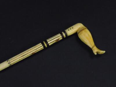 A 19thC whale bone walking cane, the partially fluted shaft with baleen washers, the sperm whale tooth handle carved as a Victorian lady's leg, 85.5cm high.