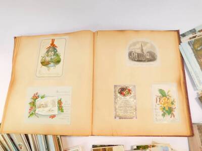 Edwardian and later topographical postcards and greetings cards, together with a Victorian scrap book. (quantity) - 2