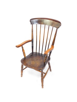 A Victorian oak and elm lady's stick back kitchen chair, raised on turned legs united by an H frame stretcher.