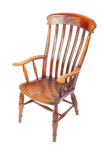 A Victorian oak and elm lath back kitchen chair, raised on turned legs united by an H frame stretcher.