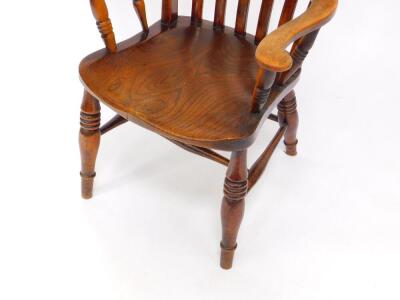 A Victorian oak and elm lath back kitchen chair, raised on turned legs united by an H frame stretcher. - 3