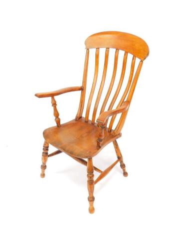 A Victorian oak and elm lath back kitchen chair, raised on turned legs united by an H frame stretcher.