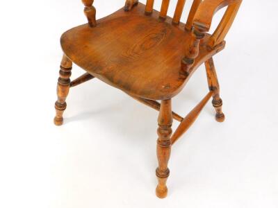 A Victorian oak and elm lath back kitchen chair, raised on turned legs united by an H frame stretcher. - 3