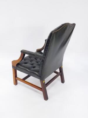 A Georgian style mahogany and green leather open armchair, with button back, over stuffed seat and arm rests, raised on square fluted legs, united by an H frame stretcher. - 3