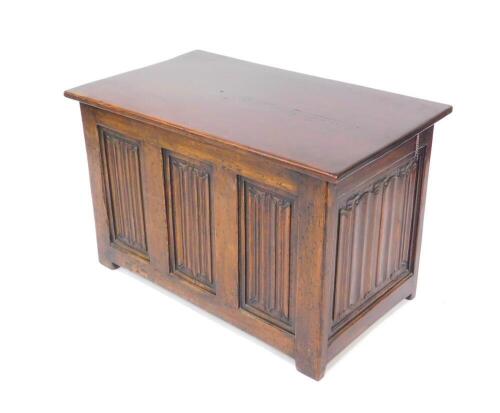 An oak blanket chest, with a linen fold panelled front and sides, 57.5cm high, 92cm wide, 53cm deep.