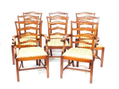 A set of eight Reprodux mahogany Georgian style ladder back dining chairs, with drop in seats, raised on fluted legs, united by an H frame stretcher, comprising a pair of carvers and six single chairs.