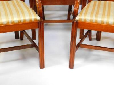 A set of eight Reprodux mahogany Georgian style ladder back dining chairs, with drop in seats, raised on fluted legs, united by an H frame stretcher, comprising a pair of carvers and six single chairs. - 3