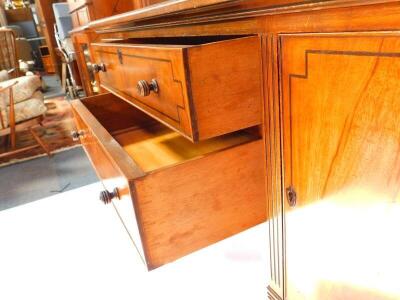 A George IV mahogany and ebony line inlaid sideboard, with splash back, two central drawers flanked by a pair of cupboard doors, raised on turned and fluted cylindrical legs, 112cm high, 151.5cm wide, 54cm deep. - 4