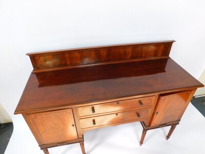 A George IV mahogany and ebony line inlaid sideboard, with splash back, two central drawers flanked by a pair of cupboard doors, raised on turned and fluted cylindrical legs, 112cm high, 151.5cm wide, 54cm deep. - 6