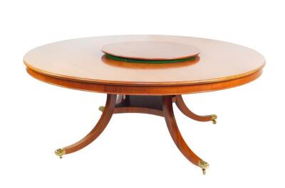 A B Knight & Son reproduction Georgian mahogany circular dining table, with central lazy Susan, raised on outswept legs, united by a square under tier, brass lion paw capped on castors, 74cm high, 188cm diameter.