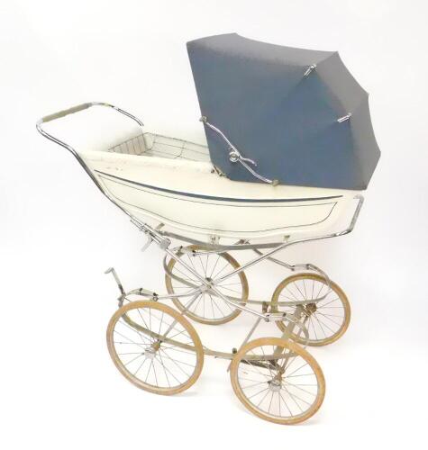 A Marmet coach built pram, with a blue trimmed white body, grey hood and blue floral interior against a white ground, sprung chassis, Four Stead's of York, 114cm wide.