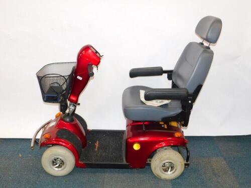 A FreeRider Mayfair red mobility scooter, model FR168-4, with battery and instructions.