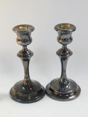 A pair of George V loaded silver candlesticks, Chester 1927, 14.13oz all in, 15.5cm high, together with a silver tea scoop spoon, Birmingham 1928, and an Edward VII silver napkin ring, Chester 1904, 0.73oz., and a pair of plated sugar tongs. - 2