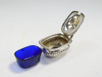 A George V silver pepperette, Birmingham 1919, a Victorian silver pepperette, Chester 1900, a George V silver mustard pot with blue glass liner, Birmingham 1918, and an Edward VII silver semi fluted mustard pot with blue glass liner, Birmingham 1904, 5.60 - 3