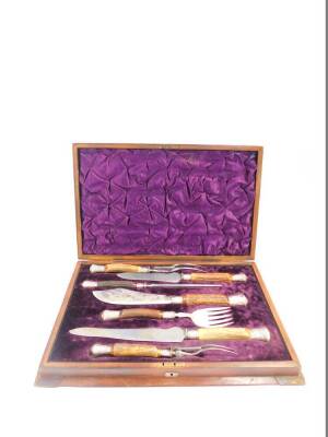 A Victorian composite horn and silver mounted serving set, comprising a pair of fish servers, a pair of carving knives and forks, and a steel, cased, Sheffield 1894 - 98.