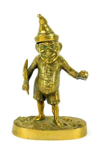 A Victorian brass novelty ink well modelled as Mr Punch, in standing pose, holding a quill and ink well, raised on an oval base, 15.5cm high.