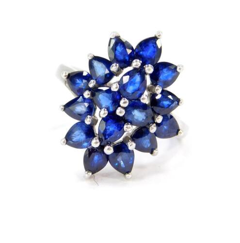 A silver and sapphire floral cluster ring, 4.32 carats, size N, with certificate.