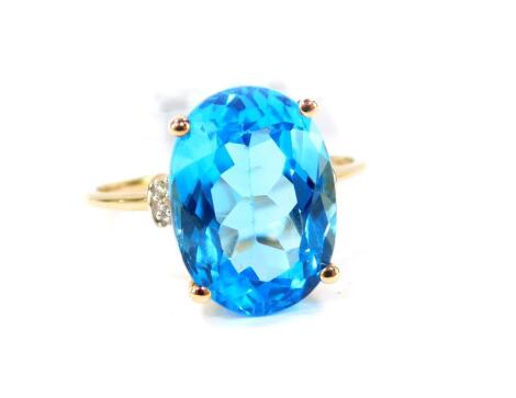 A 9ct gold and Swiss blue topaz ring, with zircon set shoulders, topaz 7.74 carats, size O, 1.68g gold, with certificate.